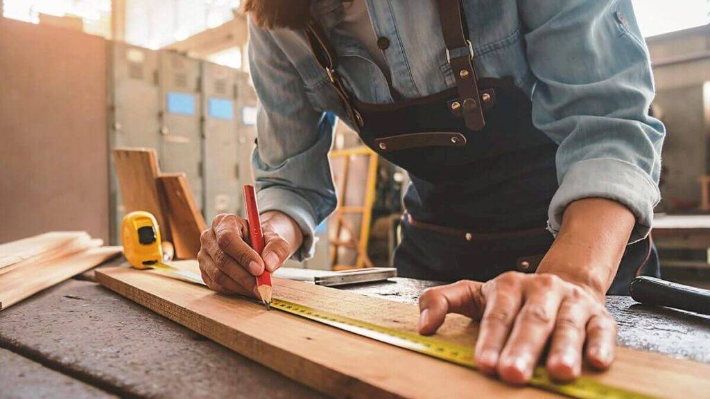 Carpenter working on wood repair and furniture installation in Dubai.