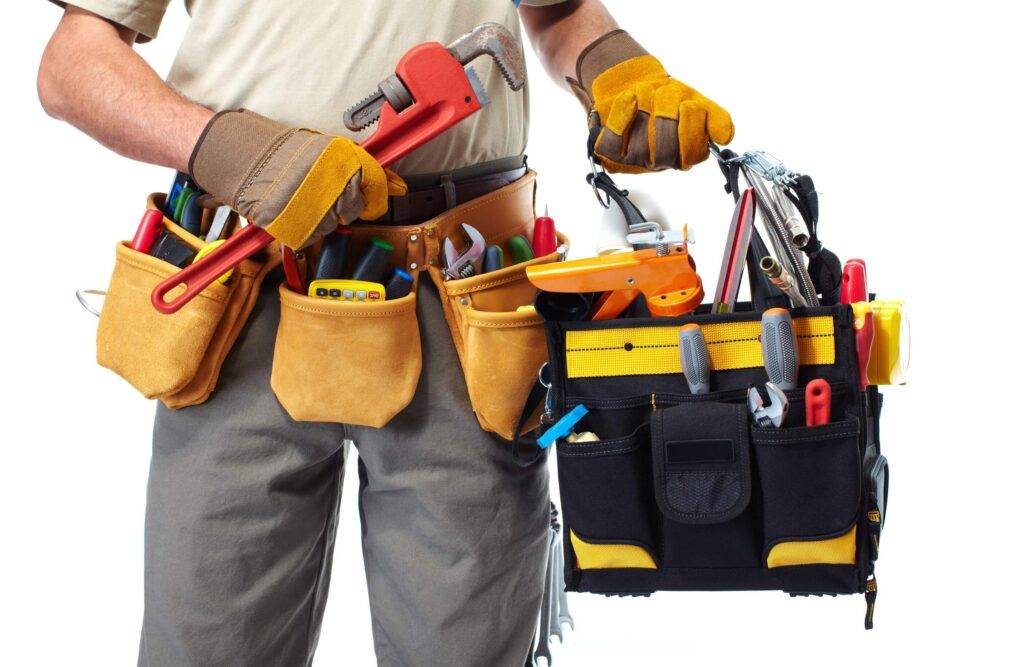 Handyman holding a repair toolkit ready for maintenance service in Dubai.