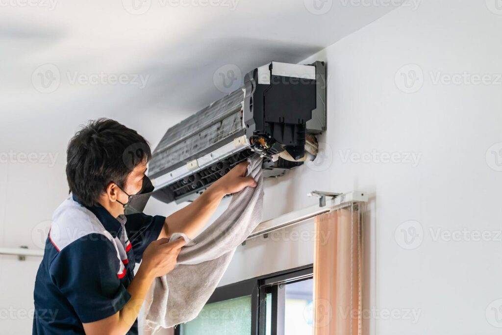 Technician providing AC indoor service and cleaning in Dubai for better air performance.