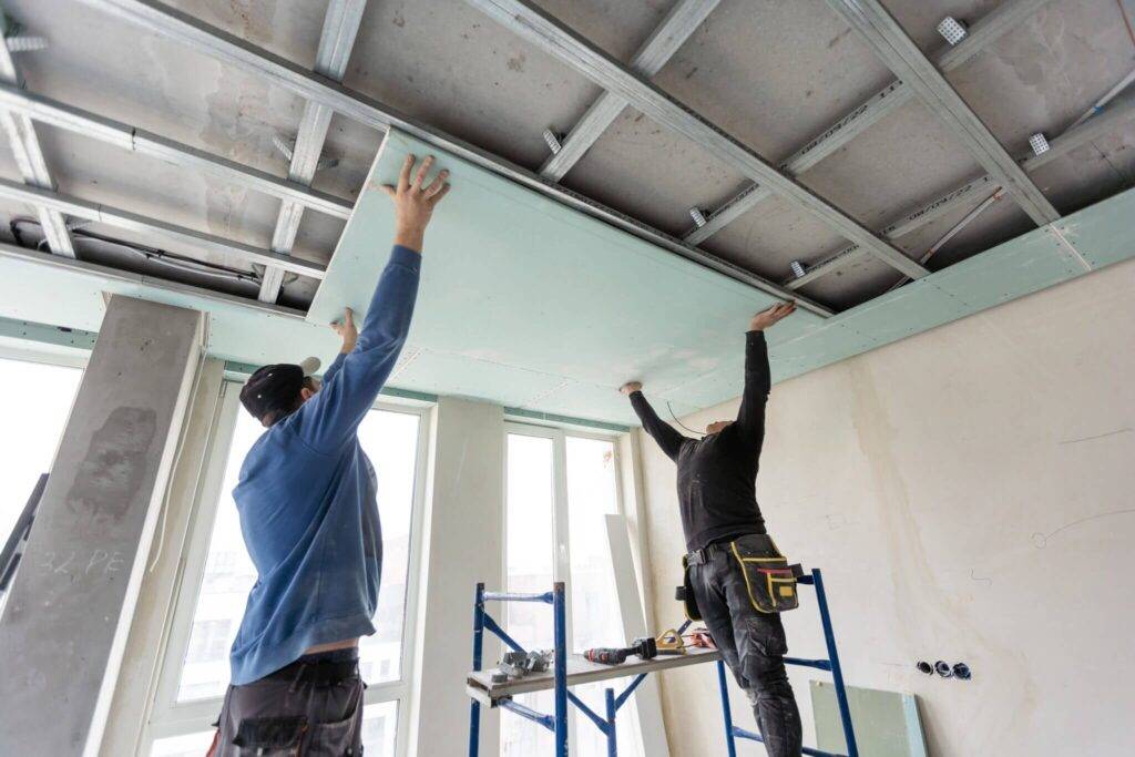 Technicians performing false ceiling installation work in Dubai homes and offices.